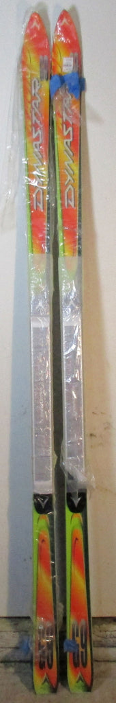 Dynastar G9 203cm NOS — full-length top sheet view of pair in factory plastic wrap showing orange, yellow, and green graphics with Power Drive race plate | LongSkisTruck